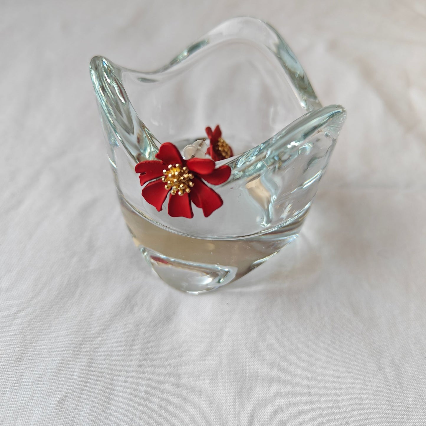 Red Poppy Flower Stud Earrings with Gold Pistils - stylized image on the bedstand, glass jewelery bowl